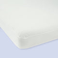 White breathable mattress with seamless corners on a light blue background.