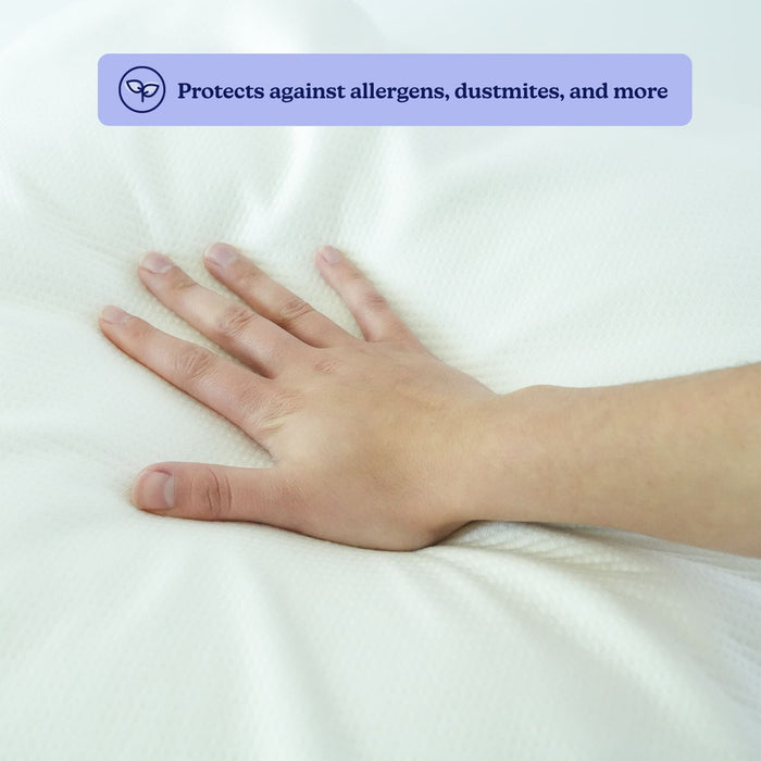 Hand pressing a hypoallergenic mattress surface showcasing dust mite and allergen protection benefits.