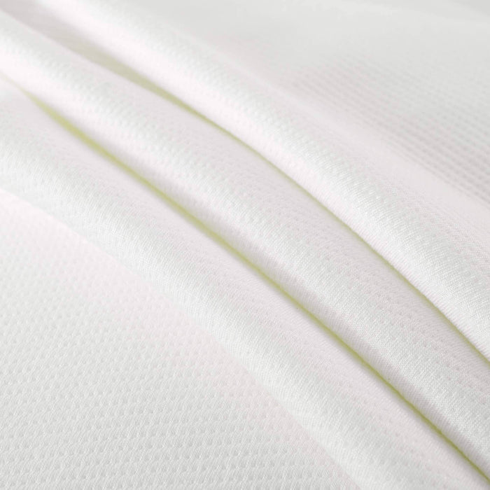 White textured fabric close-up for sewing and fashion design projects.
