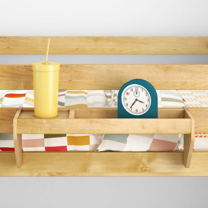 Wooden bunk bed rail shelf with teal alarm clock and yellow travel tumbler on colorful geometric bedding