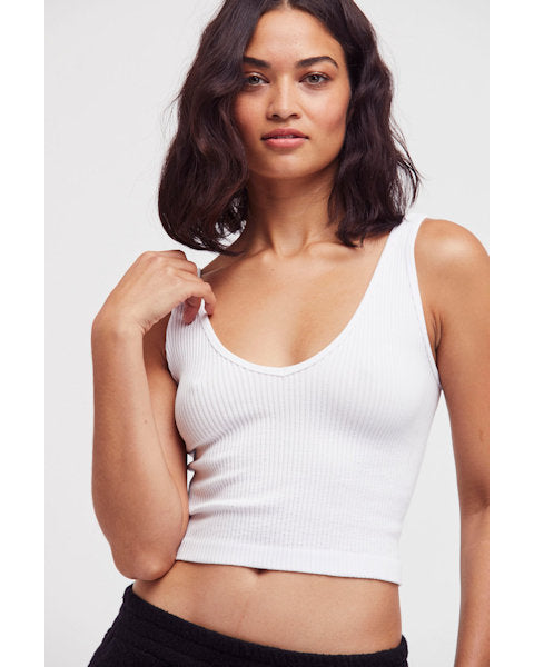 Woman in white solid rib tank on light background