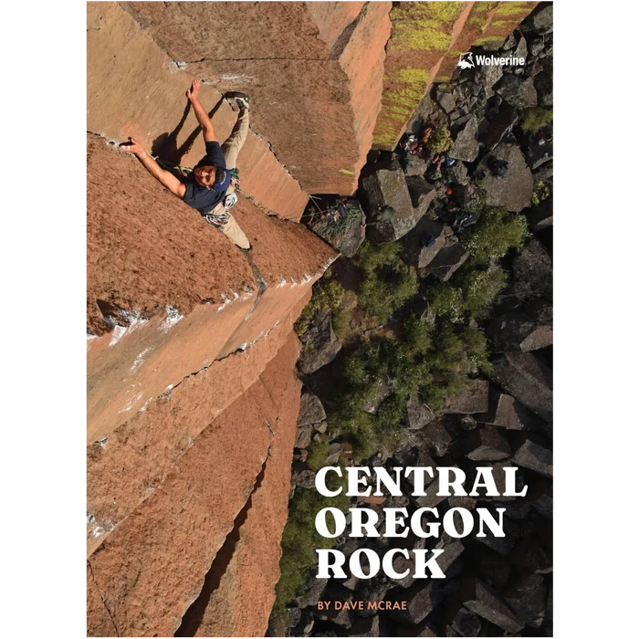 Person rock climbing on a cliff face with trees below. Advertising the Central Oregon Rock book