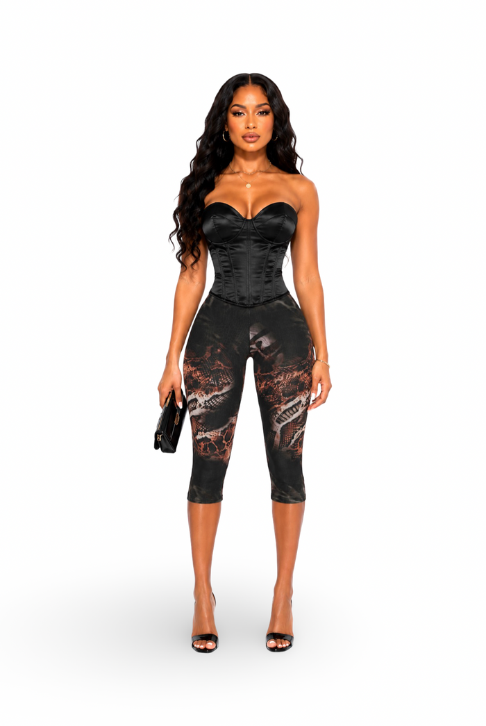 Straight Front View
Alt Text: Front view of Honor modeling Deadly Snake Print Detail Mesh Stretch Capri Leggings paired with a black satin corset top and black heels.