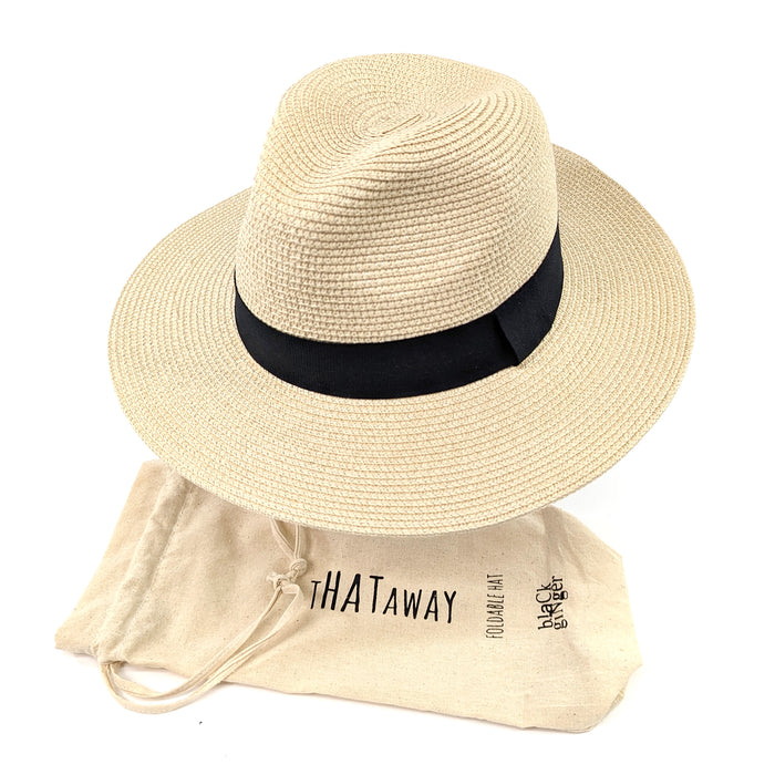 55 cm Foldable Panama sun hat made of 100% paper straw sitting on a hat stand next to its travel bag. The hat has a 7cm brim for maximum sun protection, and the travel bag makes it easy to pack and take on the go. Unisex as will suit men and women