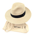 55 cm Foldable Panama sun hat made of 100% paper straw sitting on a hat stand next to its travel bag. The hat has a 7cm brim for maximum sun protection, and the travel bag makes it easy to pack and take on the go. Unisex as will suit men and women