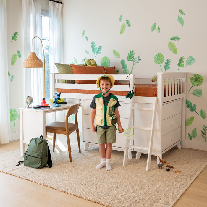 Kids bedroom with white bunk bed, green leaf wall decals, orange bedding, child in safari costume, study desk with microscope and globe, green backpack and toys