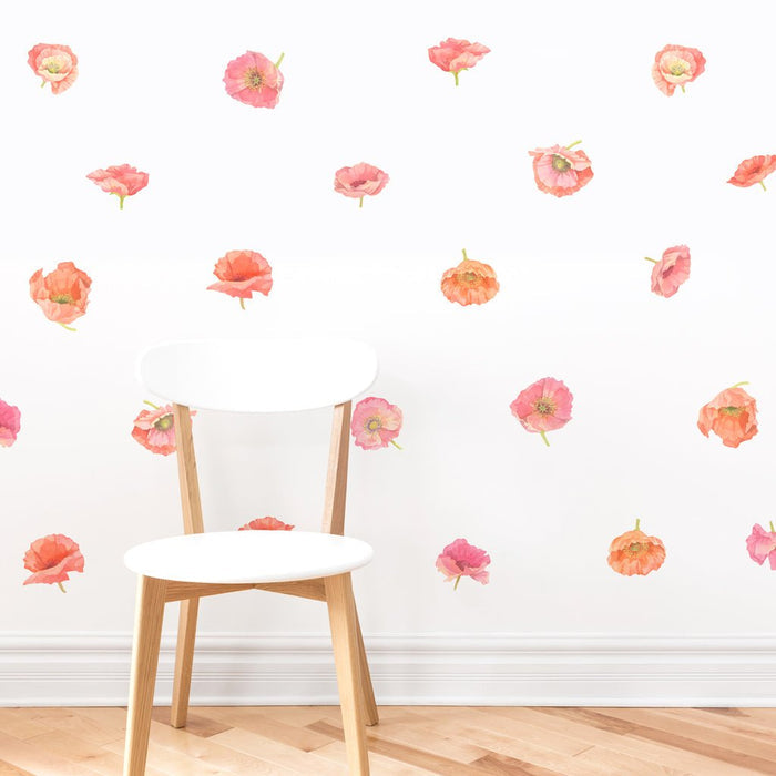 White modern wooden chair against a white wall with scattered pink and coral poppy removable floral wall decals on a hardwood floor, minimalist nursery or bedroom decor