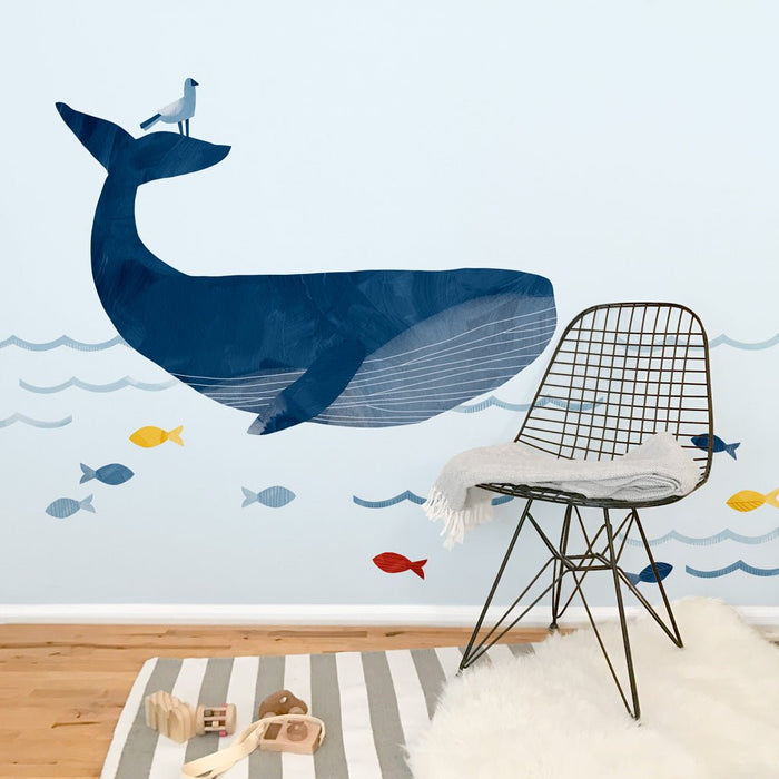 Blue whale nursery wall decal with colorful fish and waves — nautical kids' room decor and mural