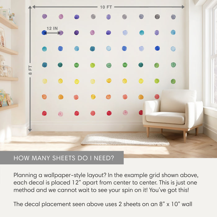 Rainbow watercolor polka-dot wall decals arranged in a grid on an 8x10 ft nursery wall with 12-inch spacing, removable wallpaper-style kids room decor by an armchair and shelves