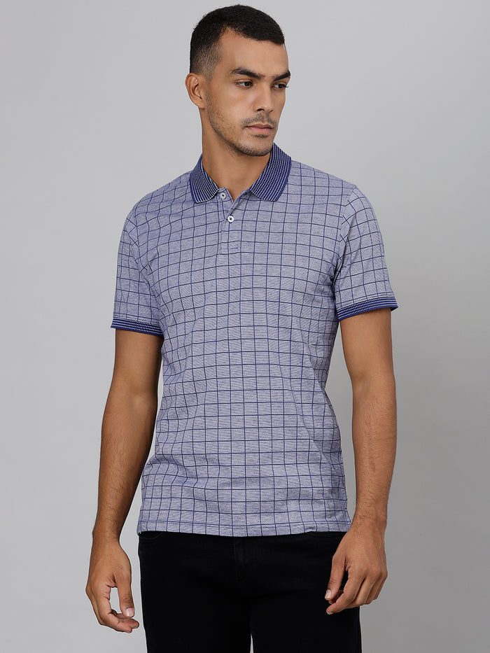 A man wearing a blue checkered polo neck T-shirt paired with black trousers.