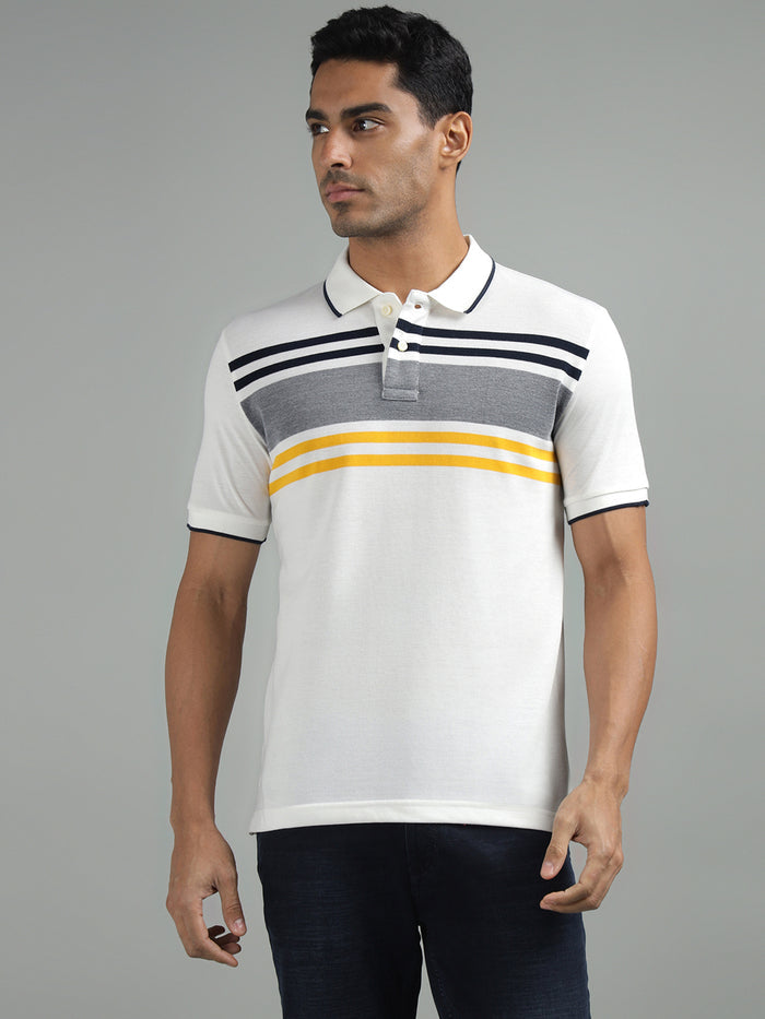 A man wearing a white polo neck t-shirt with black, grey, and yellow stripes across the chest.