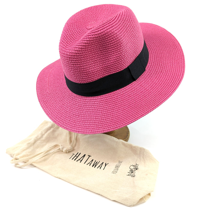 Bright pink, rollling Panama style sun hat (55cm) with 7cm brim, shown with included travel bag for easy packing and storage.