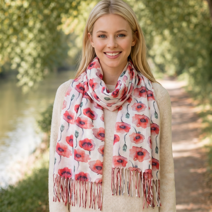 Woman wearing a floral poppy scarf in a park setting