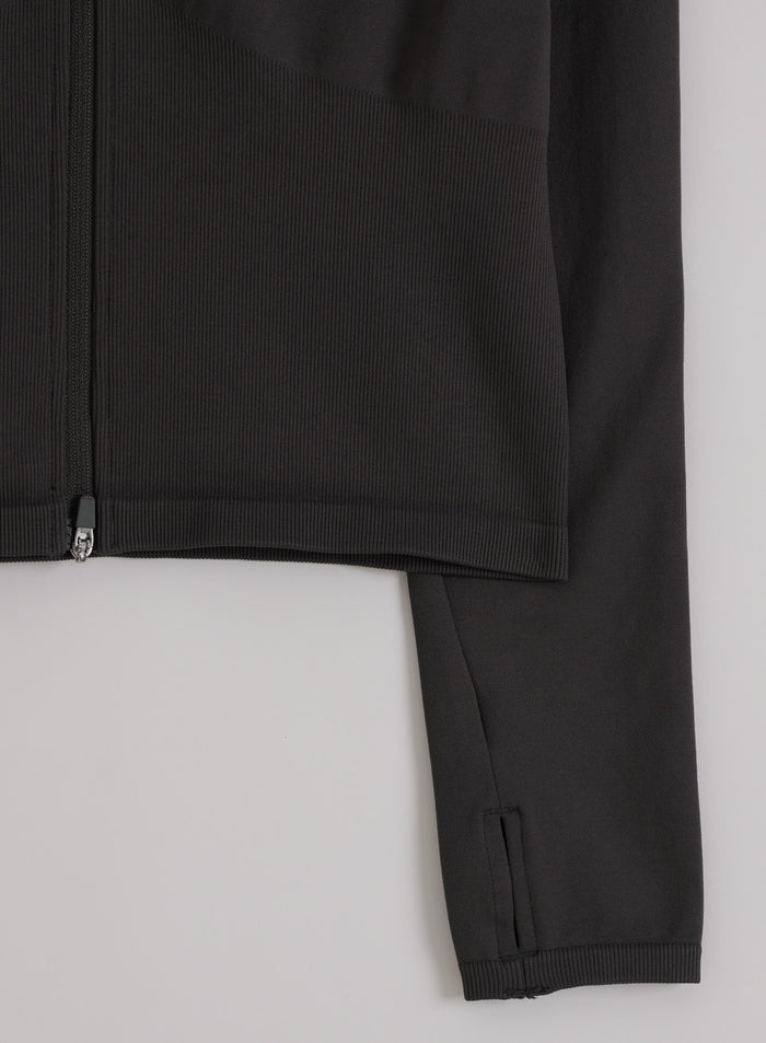 Shadow Grey aim'n Shape Seamless Zip Jacket, jossa näkyy resorihelma, vetoketju ja hihan peukaloreikä.