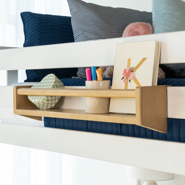 Wooden bed shelf with books and markers, perfect for kids' room organization.