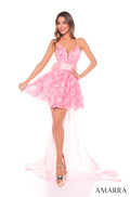 A model wears a short, flouncy Pink ruffled dress with a plunging neckline and spaghetti straps.