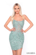 A woman wears a form-fitting, avocado green lace cocktail dress with sparkly floral embroidery.