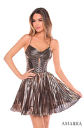 A model wears a copper metallic pleated corset dress with a fitted bodice and flared skirt.