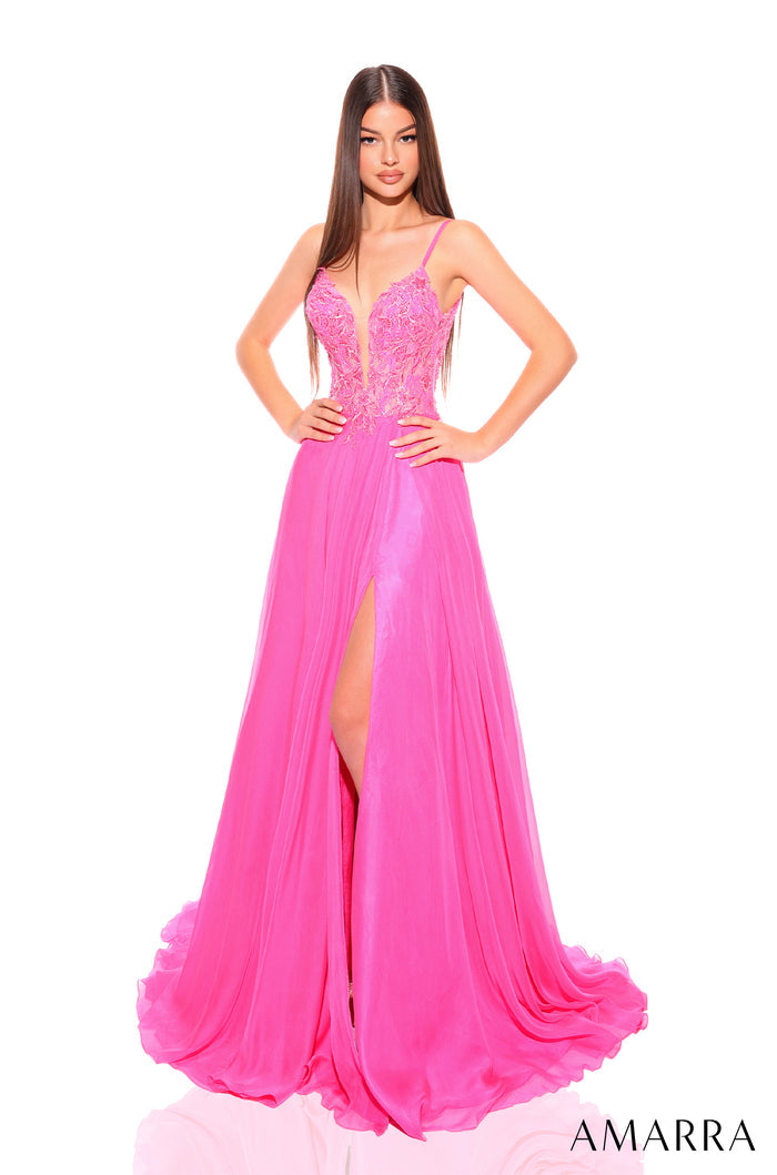 A model wears a long fuchsia evening gown with a lace bodice and high side slit.