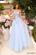 A light blue one-shoulder ball gown with floral embellishments, photographed in a garden with pink and purple flowers.