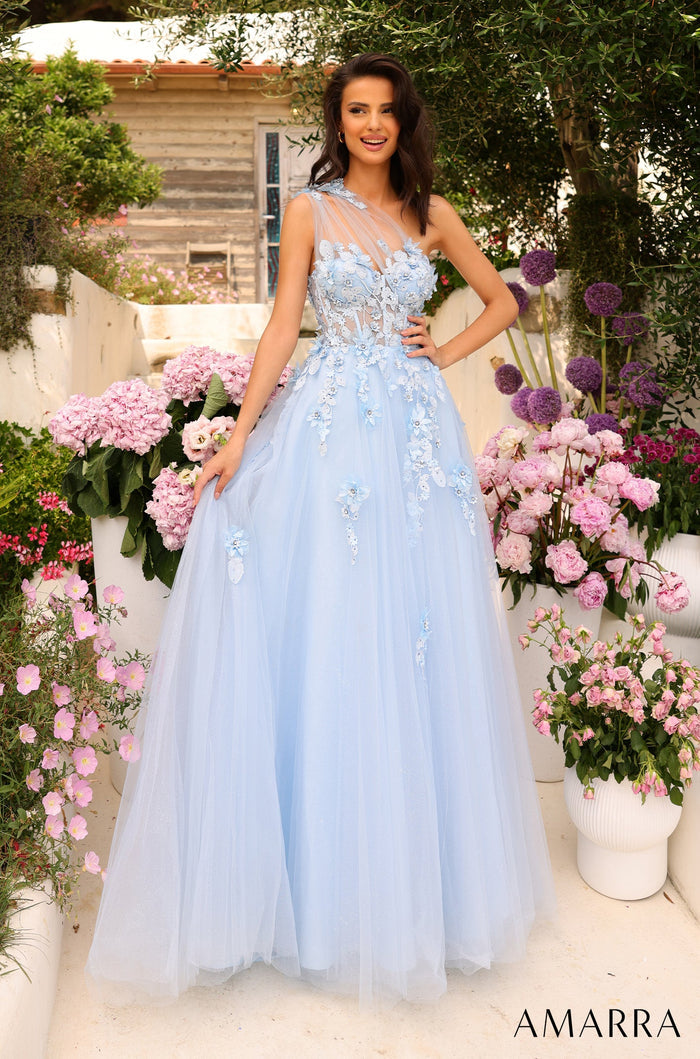 A woman wears a light blue floral ballgown amid pink and purple flowers in a garden setting.