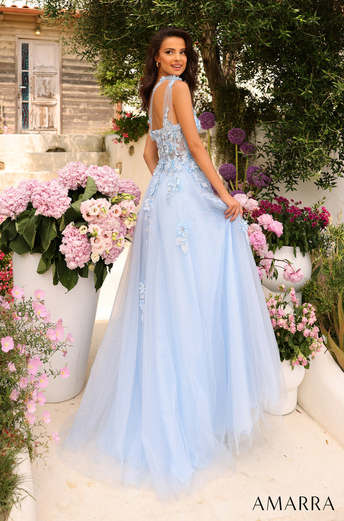 A light blue floral ball gown with 3D appliqués, posed in a garden with pink and purple flowers.