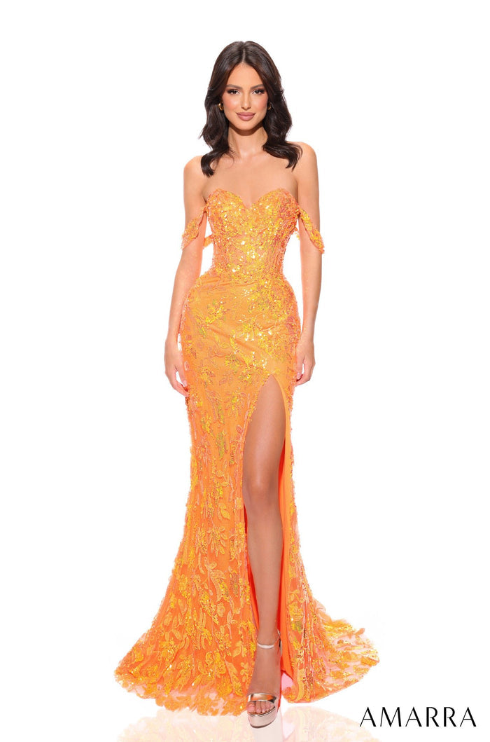 A model wears a sequined neon orange off-shoulder gown with a high slit and shimmering embellishments.