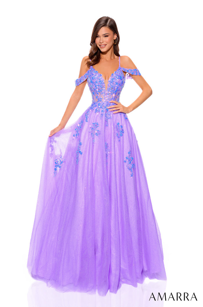 A purple ball gown with off-shoulder straps, floral embellishments, and a full tulle skirt on a model.
