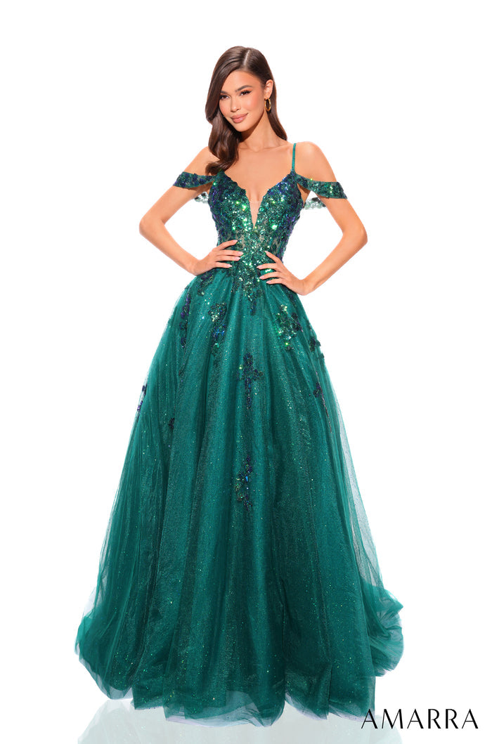 A woman wears a sparkling emerald green ball gown with off-shoulder sleeves and intricate sequined bodice.