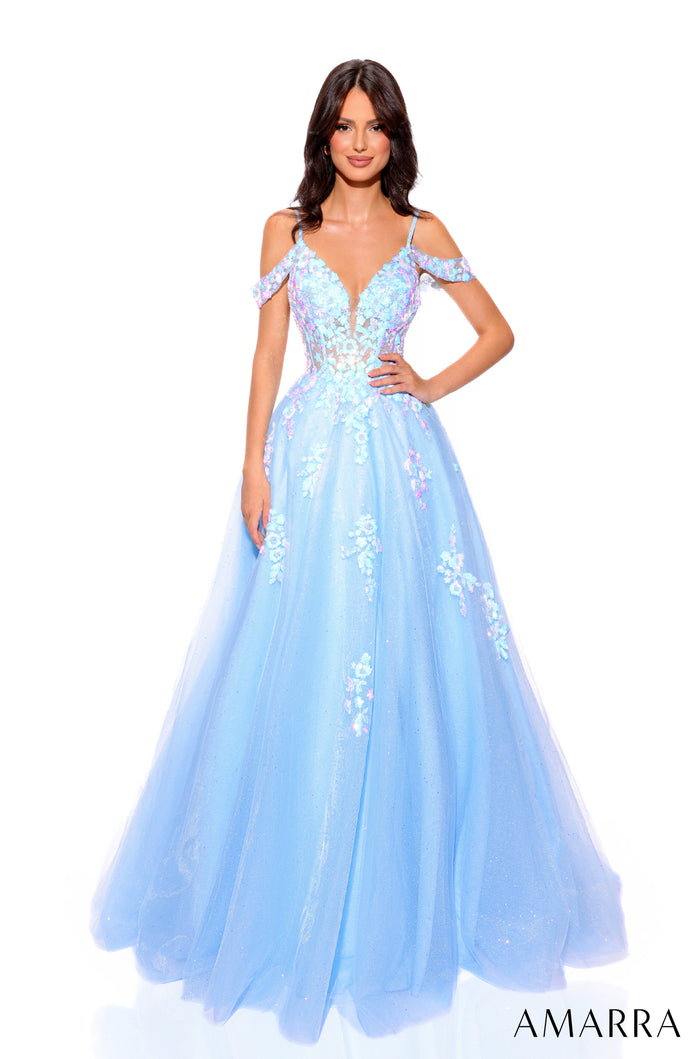 A model wears a light blue off-shoulder ball gown with floral embellishments and a full tulle skirt by Amarra.